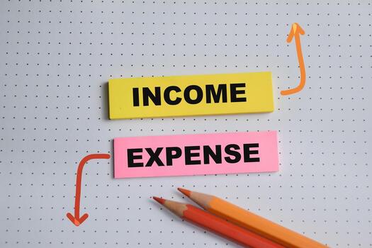 Concept of Income and expense write on sticky notes isolated on Wooden Table. photo