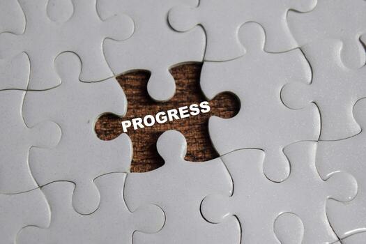 piece of jigsaw puzzle with word progress. Business and finance concept photo