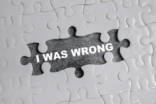 piece of jigsaw puzzle with word I was wrong. Business and finance concept photo