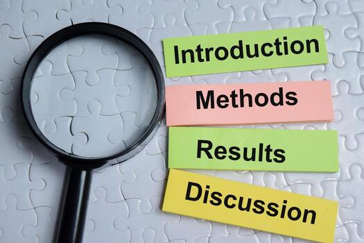 Concept of 4 parts of research. Introduction, methods, results and discussion write on sticky notes isolated on Wooden Table. photo