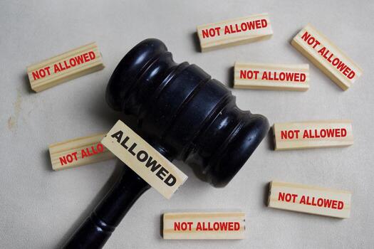 Two words allowed or not allowed. Choose allowed on stacked wooden cubes on the table. Business and finance concept photo