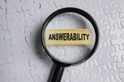 Answerability on stacked wooden cubes on the table. Business and finance concept photo