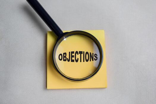 Concept of objections write on sticky notes isolated on Wooden Table. photo