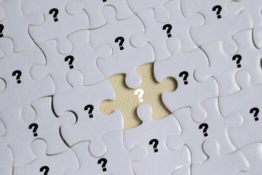 Piece of jigsaw puzzle with symbol of question mark. Business and finance concept photo