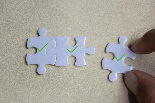 Piece of jigsaw puzzle with symbol certified and correct mark. Business and finance concept photo