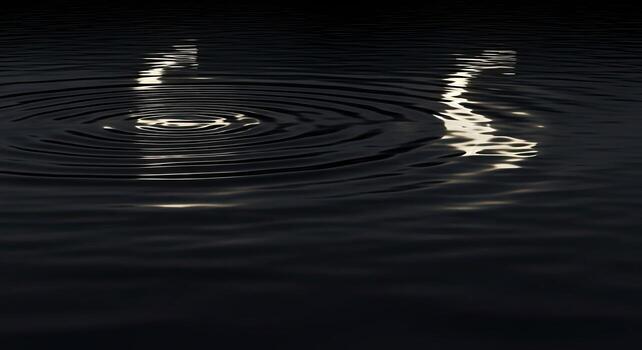 Dark water surface with concentric ripples and shimmering light reflections. photo