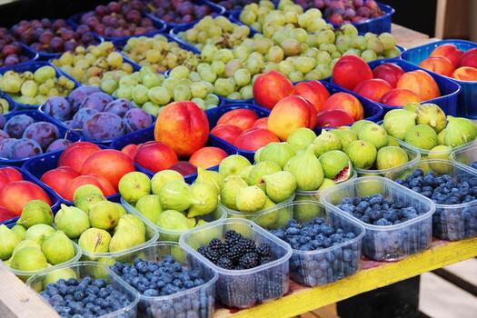 Assorted Fresh Fruits Display with Figs, Peaches, Berries, Plums, and Grapes photo