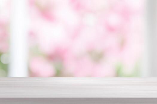 Inviting empty wooden surface with a soft-focus pink floral backdrop, ideal for product presentation photo