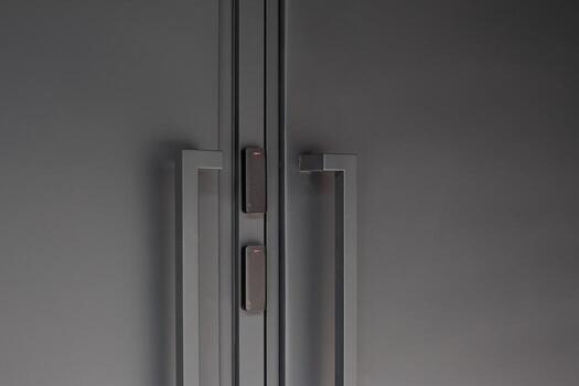 Close up of modern black doors with smart access control system, featuring minimalistic design and security technology, emphasizing convenience and sophistication in urban spaces photo