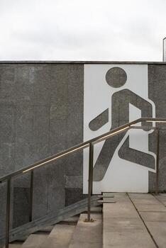 Staircase with prominent pedestrian icon sign, representing thoughtful urban design elements aimed at providing equal access. Inclusive cities, social equality and intersection of architecture photo