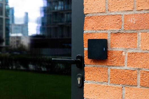 Access control system with card reader on brick wall, representing the integration of smart technologies in urban architecture. Step forward in modern construction for secure building management photo