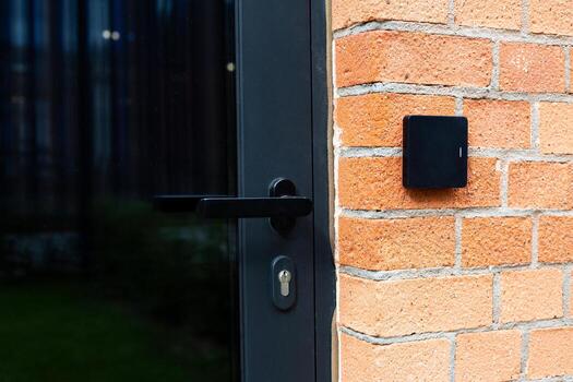 Control system on brick wall, showcasing cutting edge technology for secure building access in office buildings or commercial spaces, emphasizing infrastructure solutions photo