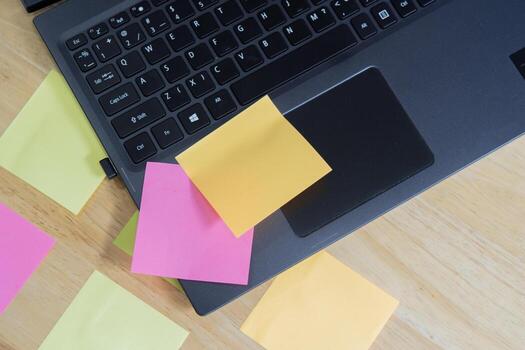 Empty sticky post note paper sheets on laptop keyboard. note list, message memory. photo