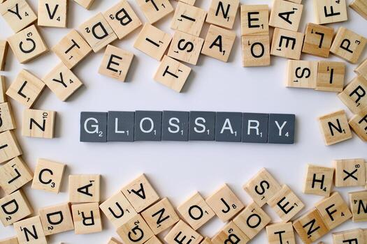 Glossary word in wooden cube blocks, dictionary definition concept, list of terms and meanings, education and knowledge idea photo