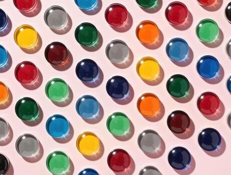 Colorful glass circles creating a vibrant pattern on pink background photo