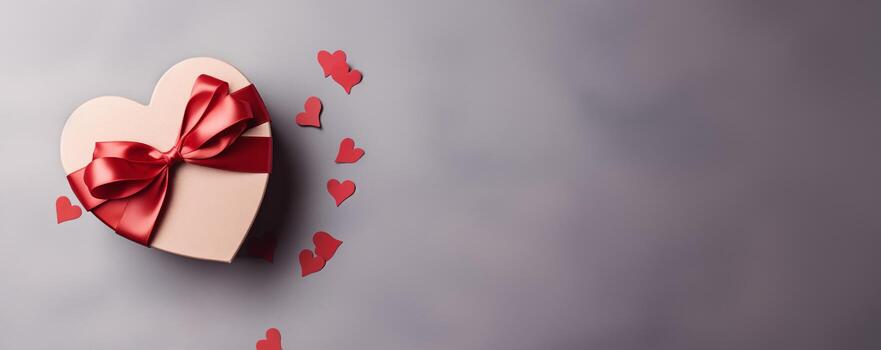 Festive box in the shape of a heart with a bow. Banner with place for text, copy space for Valentine's day, mother's day and date with copy space photo