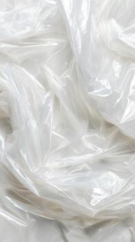 Abstracted Swirls of translucent film shimmering in diffused light creating a mesmerizing optical photo