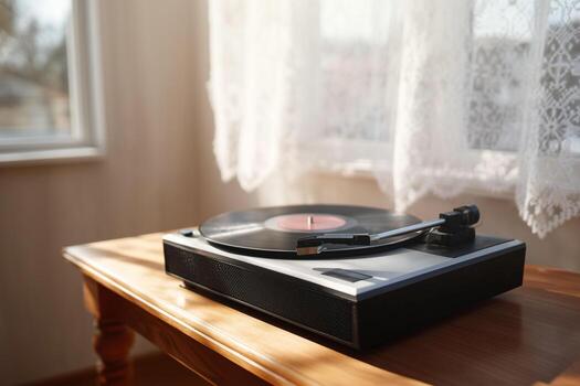 An old record player sitting on a table in front of a window photo