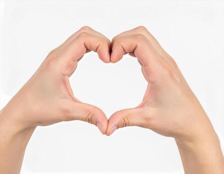 Hands making heart shape with fingers on white background. photo
