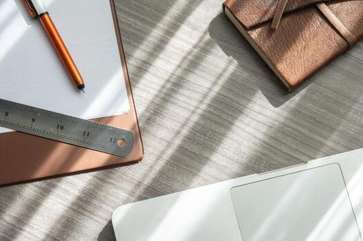 Table view of office table desk with notebook, computer, paper, pen, ruler etc. the accessories for office work. photo
