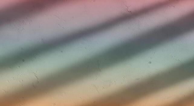 A rainbow colored wall with shadows photo