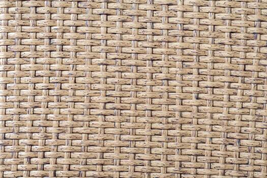 Woven wicker rattan texture creating a seamless brown background, highlighting the natural fiber weaving pattern and providing a detailed surface for various creative and decorative applications photo