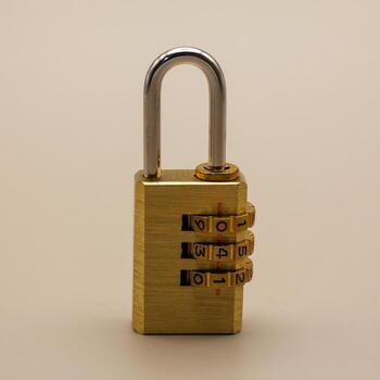 Close-up of a sturdy brass combination padlock, symbolizing security, privacy, and controlled access, standing vertically on a plain background, representing protection and safety in a modern context photo