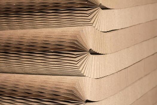 Close-up of stacked corrugated cardboard with a honeycomb structure, showcasing texture and geometric patterns photo