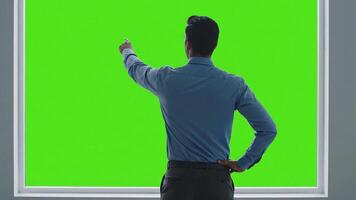 professionale interagendo con un' vasto verde schermo, simboleggiante infinito digitale possibilità, virtuale interfacce, e futuro Tech per attività commerciale e creativo soddisfare video
