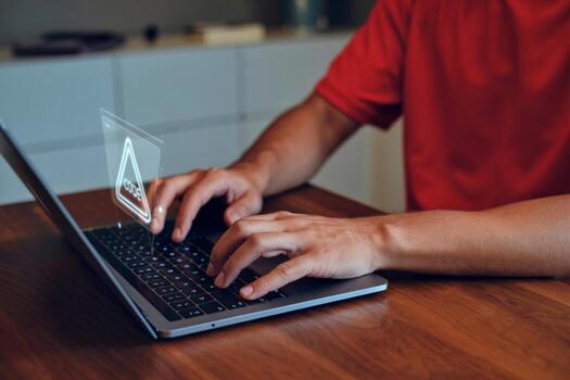 Programmer typing on laptop with glowing code symbol overhead photo