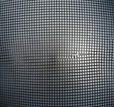Close up of a fine mesh screen with a subtle metallic sheen and grid pattern photo
