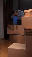 A man is standing in front of boxes in an empty room video