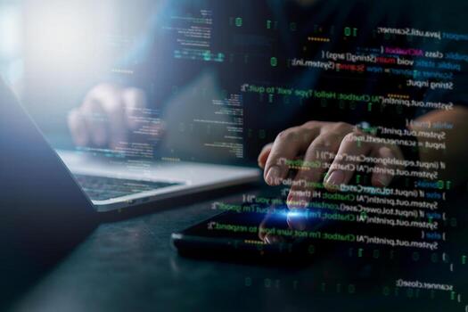 A man using a laptop computer with code on the screen photo