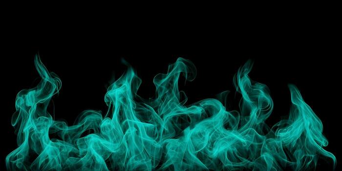 Vibrant teal smoke flows and rises with dynamic motion against a pure black background creating an abstract effect photo