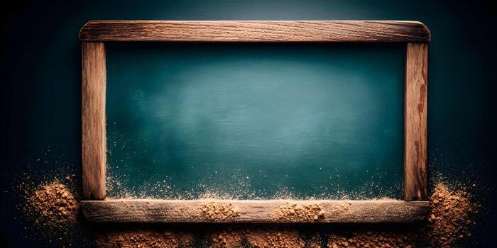 An empty old green chalkboard with a rustic wooden frame is covered with chalk dust at the bottom ready for new messages photo