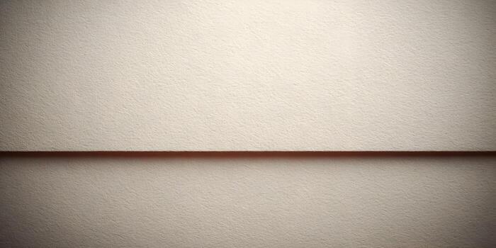 A close up of cream textured paper with a subtle horizontal line creating a divided abstract background photo