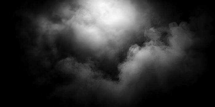 White smoky mist dissipates and spreads on a solid black background creating an atmospheric abstract effect photo