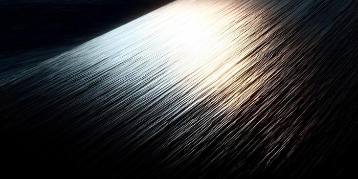 Illuminated dark textured parallel lines create an abstract background with a gradient of cool and warm light photo