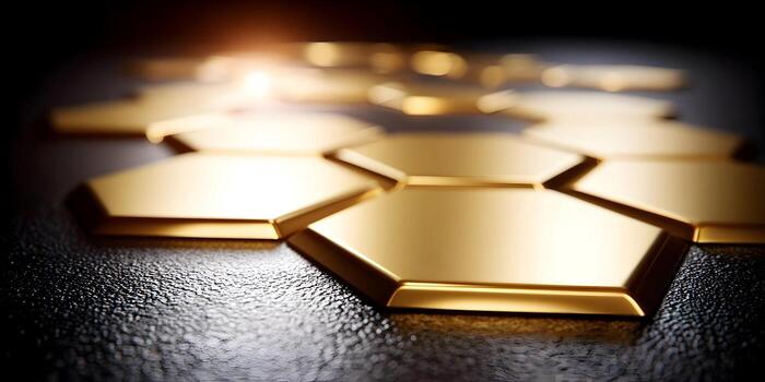 Golden hexagonal shapes arranged on a textured dark surface with a bright light source creating a luxurious abstract background photo