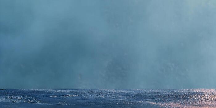 A blue textured foreground surface is set against a smooth light blue gradient background creating an abstract composition photo