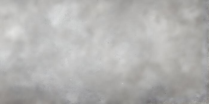 A textured gray concrete surface forms an abstract background with a rough grainy appearance photo