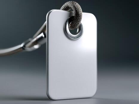 Rectangular metallic tag with rounded edges, attached through a circular hole with a thick, textured rope. Close-up view, showcasing shiny surface and intricate rope details photo