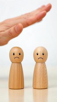 Hand threatening wooden figures isolated on white background photo