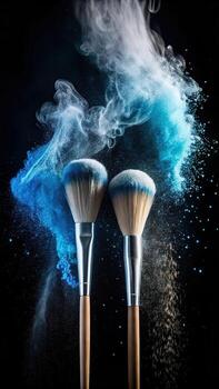 Two makeup brushes exploding with blue and teal powder against black background photo