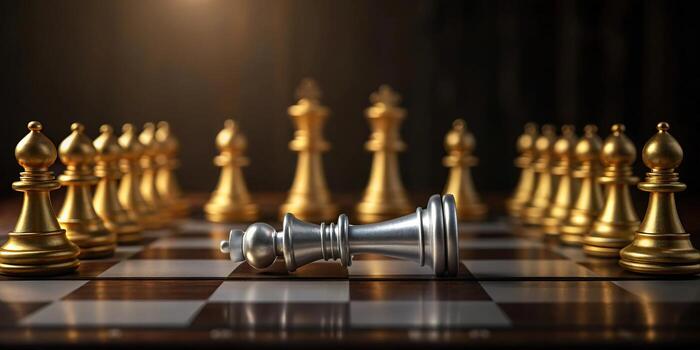 Defeated silver king chess piece on chessboard photo