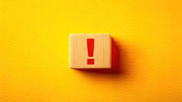 Exclamation mark on wooden block on yellow photo