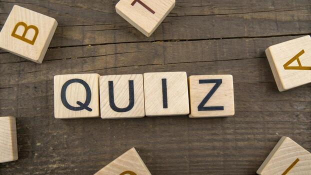 Quiz word on wooden blocks on wooden table photo