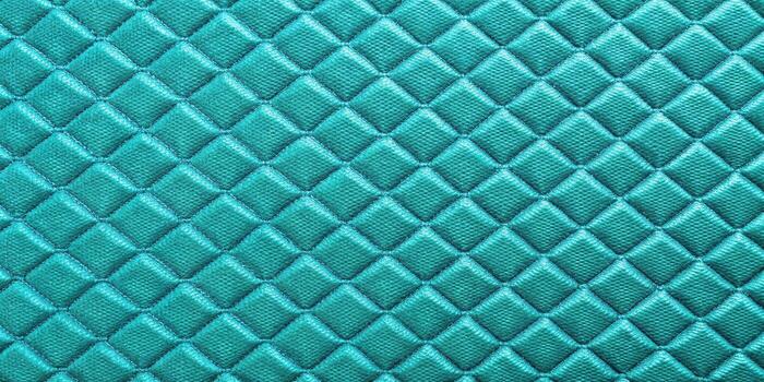 Turquoise quilted fabric texture as background photo