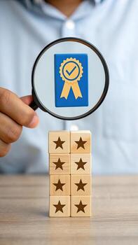 Magnifying glass focusing on quality badge and star photo