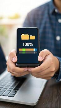 Man holding smartphone showing file transfer complete photo